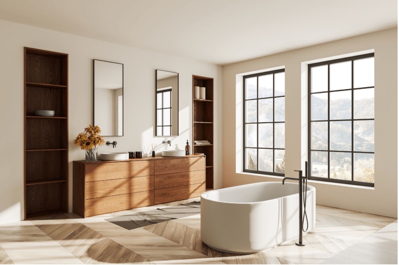 Modern bathroom with wood vanity, large mirrors, and a freestanding tub by sunlit windows