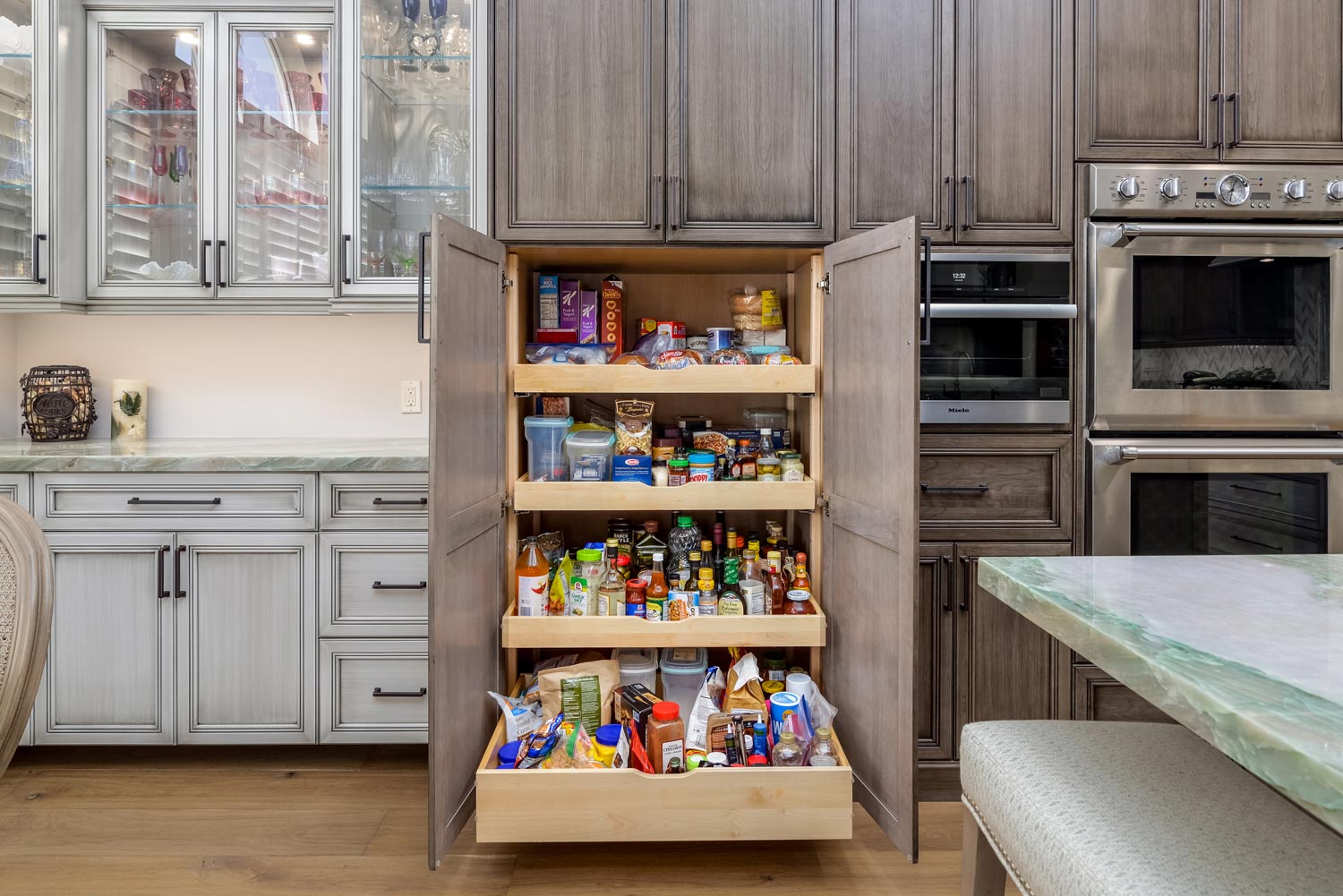 Open pantry drawer filled with snacks in a modern kitchen