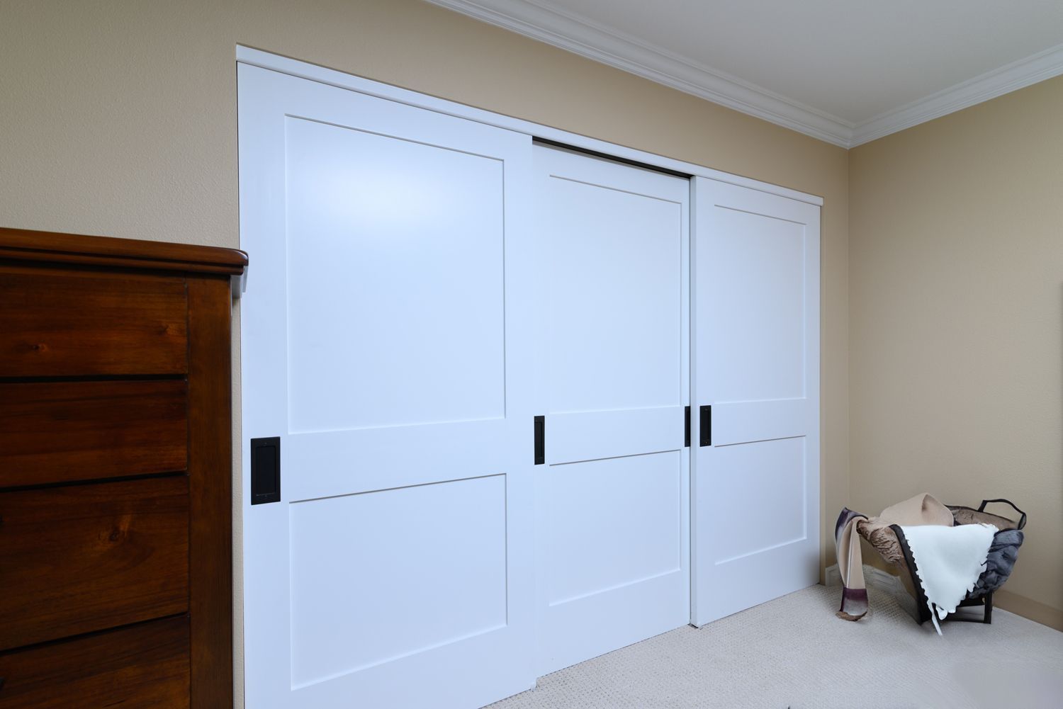 Image of  a bedroom closet with 3 white doors, Oak Park, CA primary bathroom addition, closet addition   