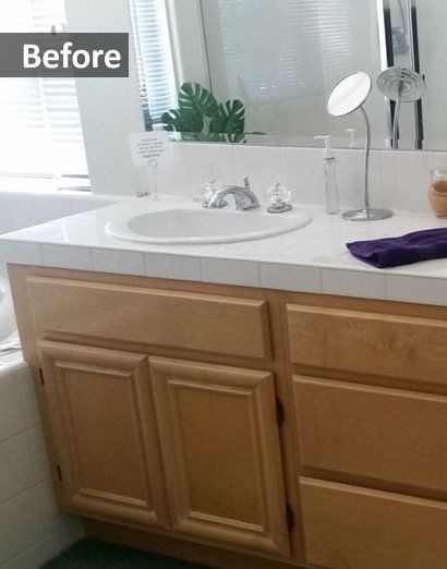 Before view of a bathroom vanity with white countertop, sink, mirror, and light wood cabinets