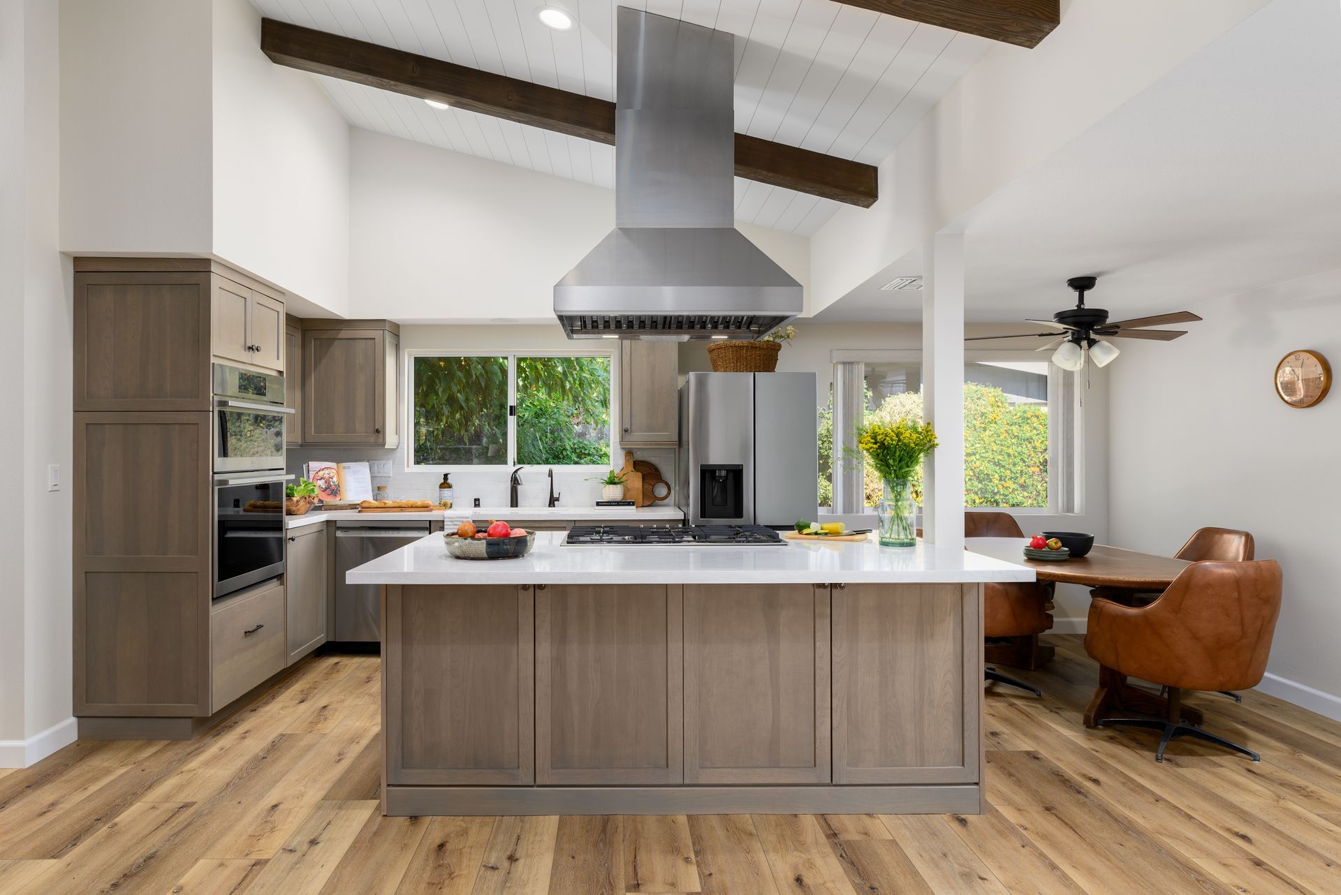 Open renovated kitchen with Omega cabinets, new island, and vaulted shiplap ceiling with stained beams, Greater Mulwood Calabasas remodel by Westside Remodeling