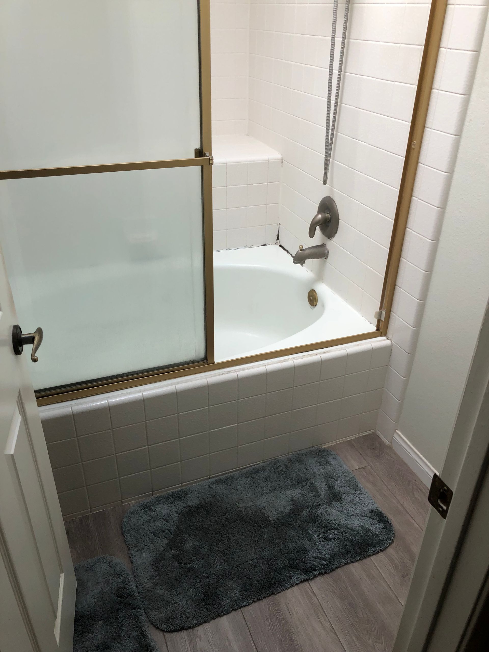 Outdated tub-shower combo before remodel, Leisure Village Camarillo primary bathroom