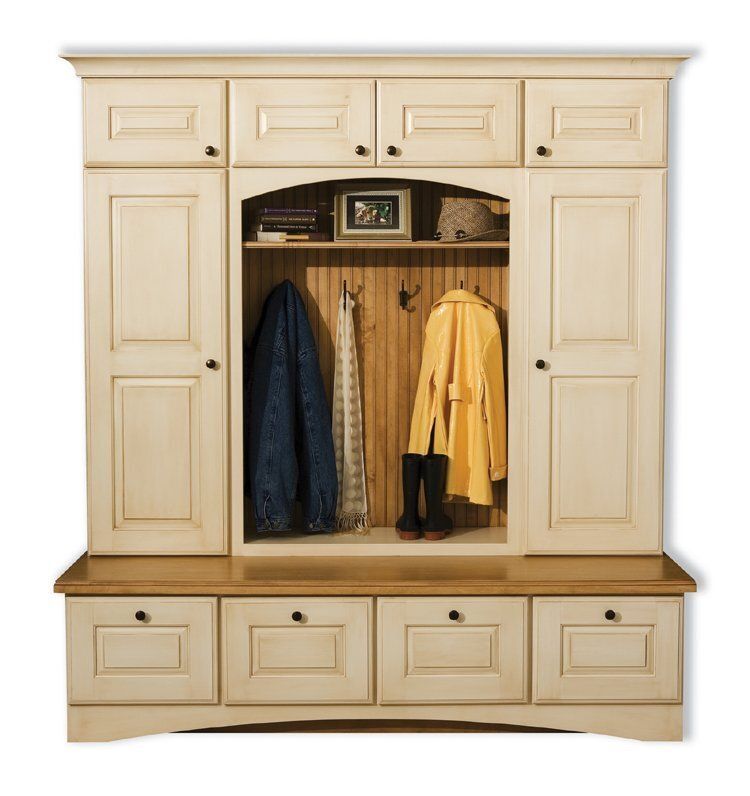 Cream-colored wooden hall cabinet with hooks, shelves, and drawers, holding coats and boots.