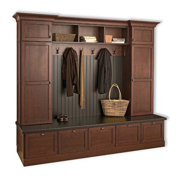 Wooden hallway hall tree with bench, cabinets, hooks, coats, and a wicker basket