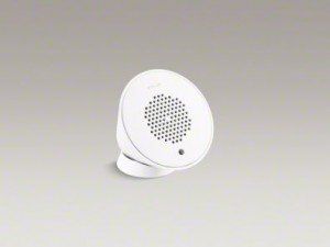 White round tabletop speaker with perforated grille on a plain light background