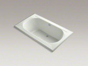 White rectangular bathtub on a light floor, viewed from above at an angle.