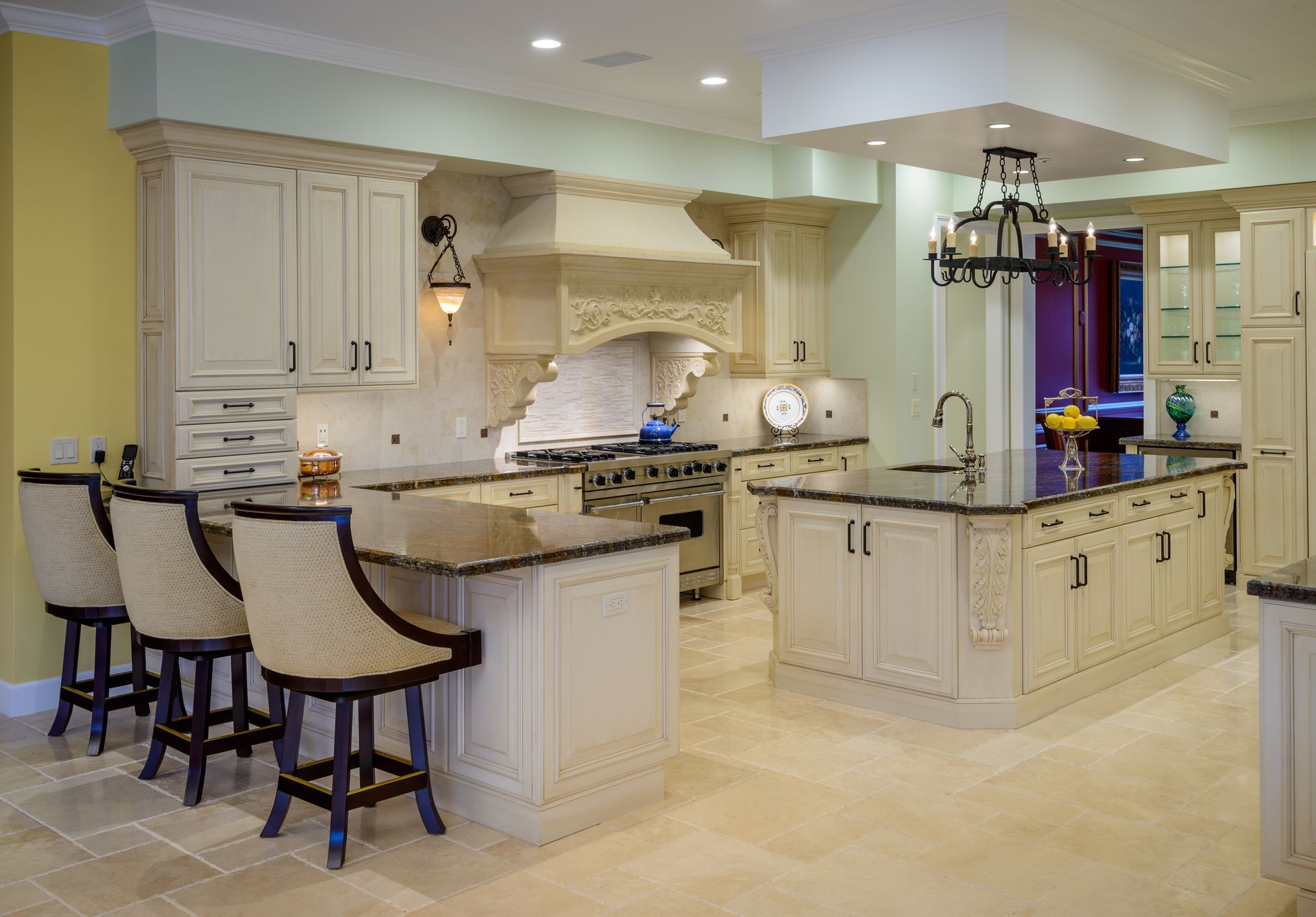 Traditional-style kitchen with custom Omega cabinets, carved hood shroud, large island, and peninsula, Sherwood Country Club Lake Sherwood remodel by Westside Remodeling