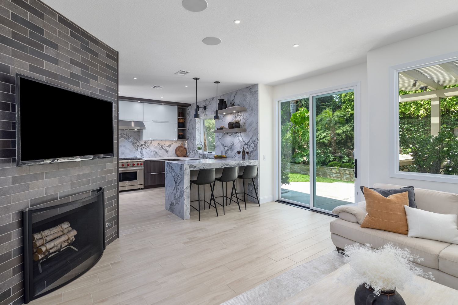 image shows a living room's view to the kitchen, fireplace and glass doors to backyard, Rancho Conejo Community, Newbury Park, CA Home Remodel, Living Room Remodel