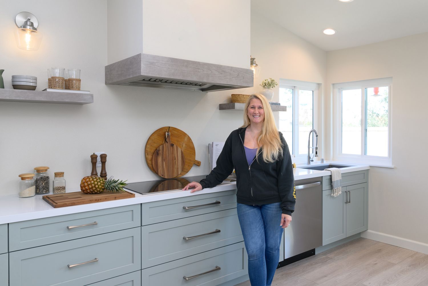 homeowner in her new light green and white custom designed & custom built kitchen remodel, Rancho Conejo Neighborhood, Newbury Park, CA 