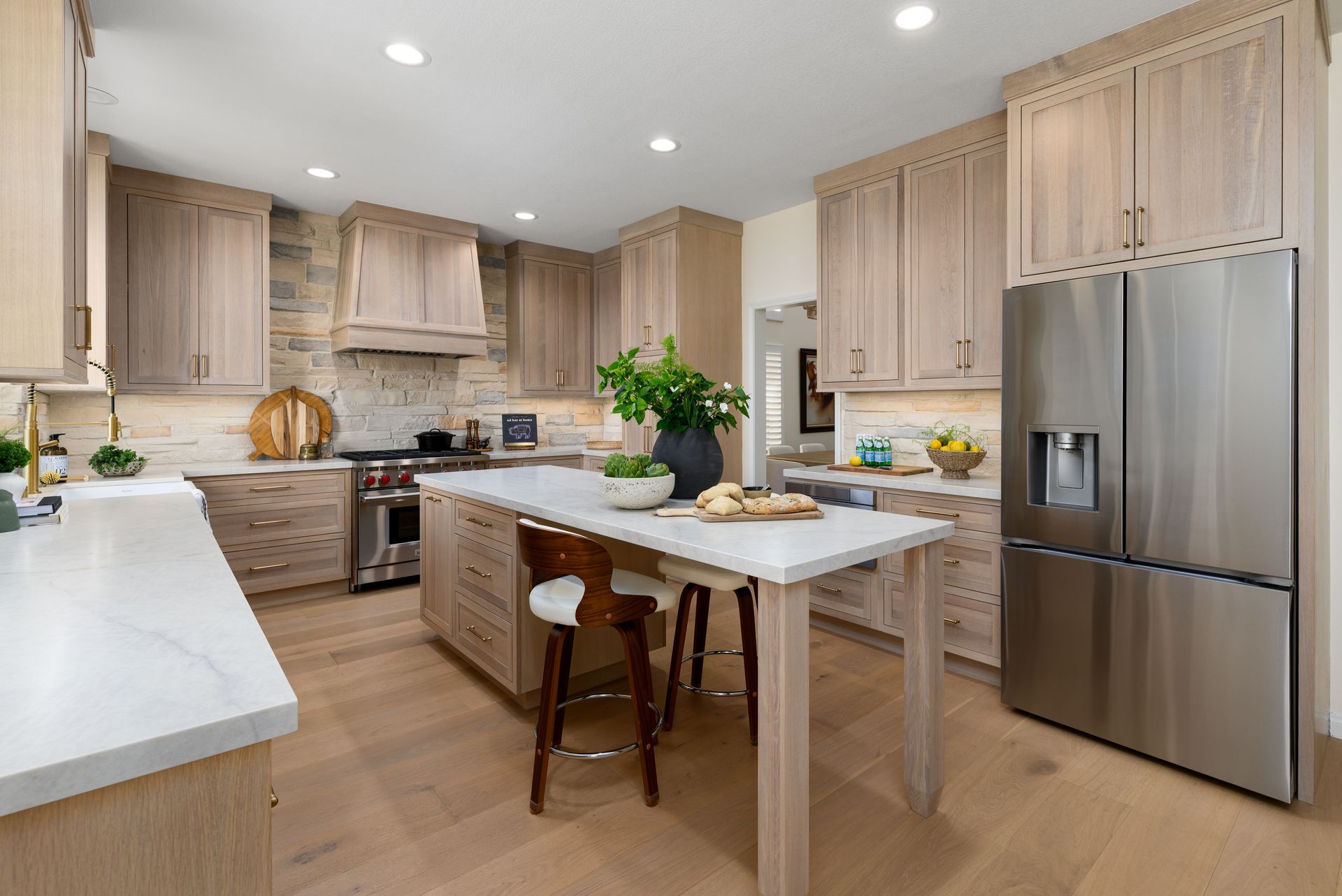 Renovated kitchen with quartersawn white oak cabinets, extended island seating, and custom hood shroud, Casa Conejo Newbury Park remodel by Westside Remodeling