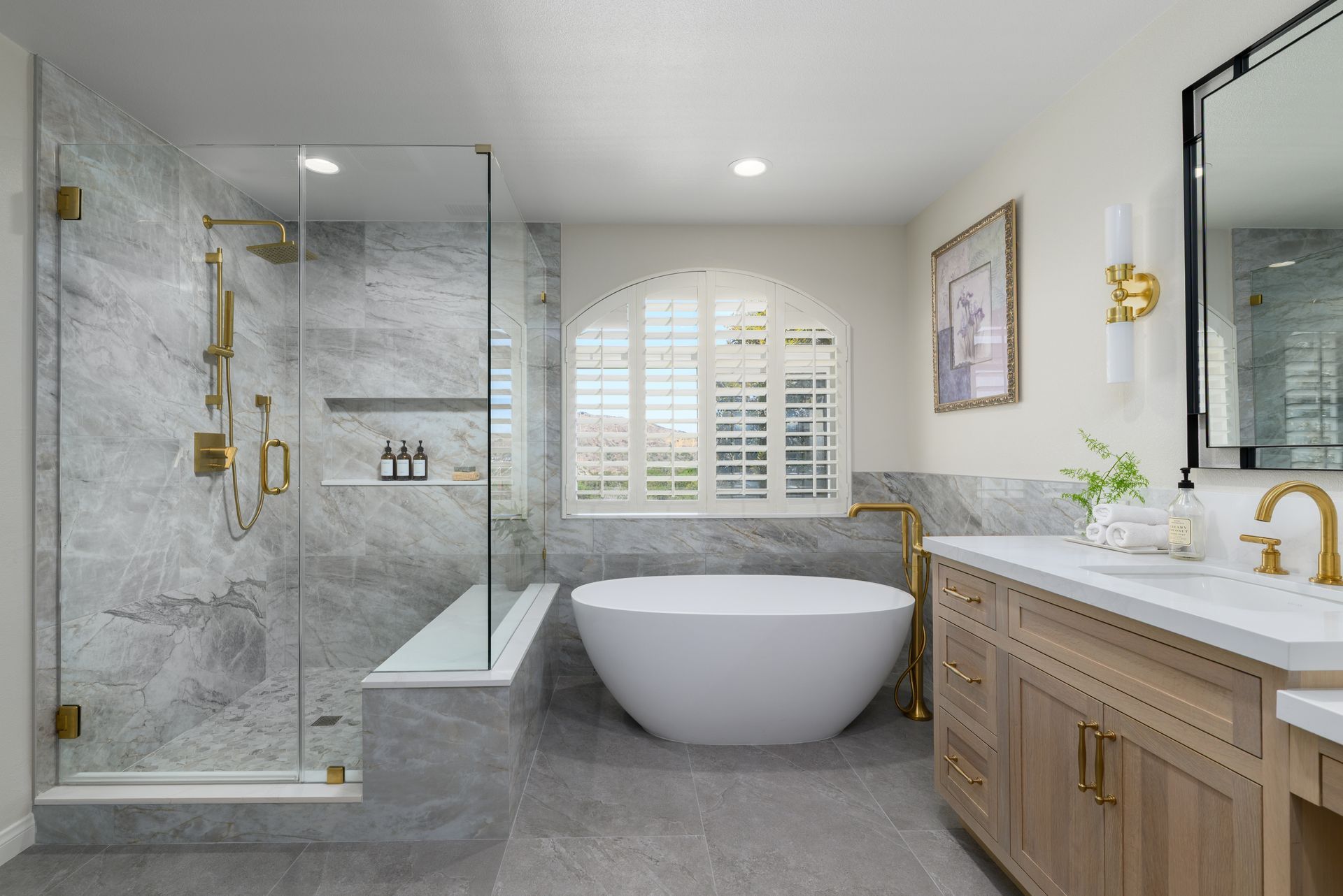 Renovated primary bathroom with freestanding tub, marble tile glass shower, and quartersawn white oak vanity, Casa Conejo Newbury Park remodel by Westside Remodeling