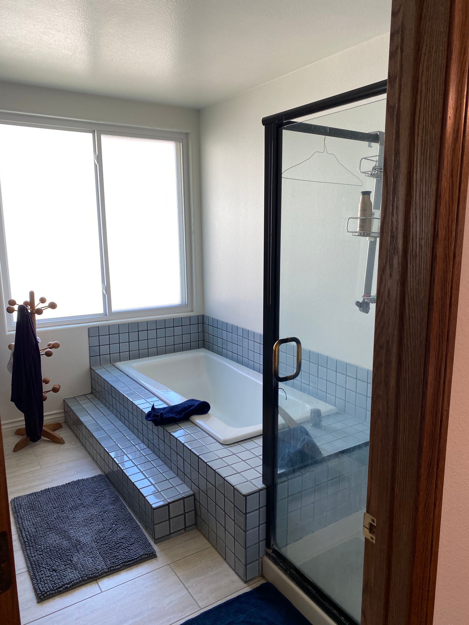 Dated primary bathroom tub platform and shower before remodel, Morrison Estates Sutton Valley Oak Park