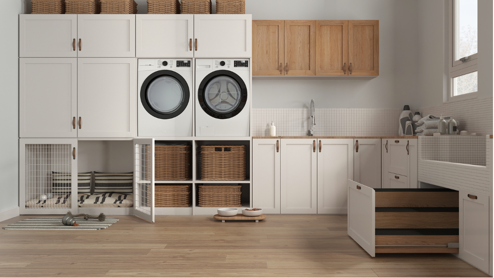 Modern laundry room with stacked washer-dryer, white cabinets, wooden shelves, and a sink.