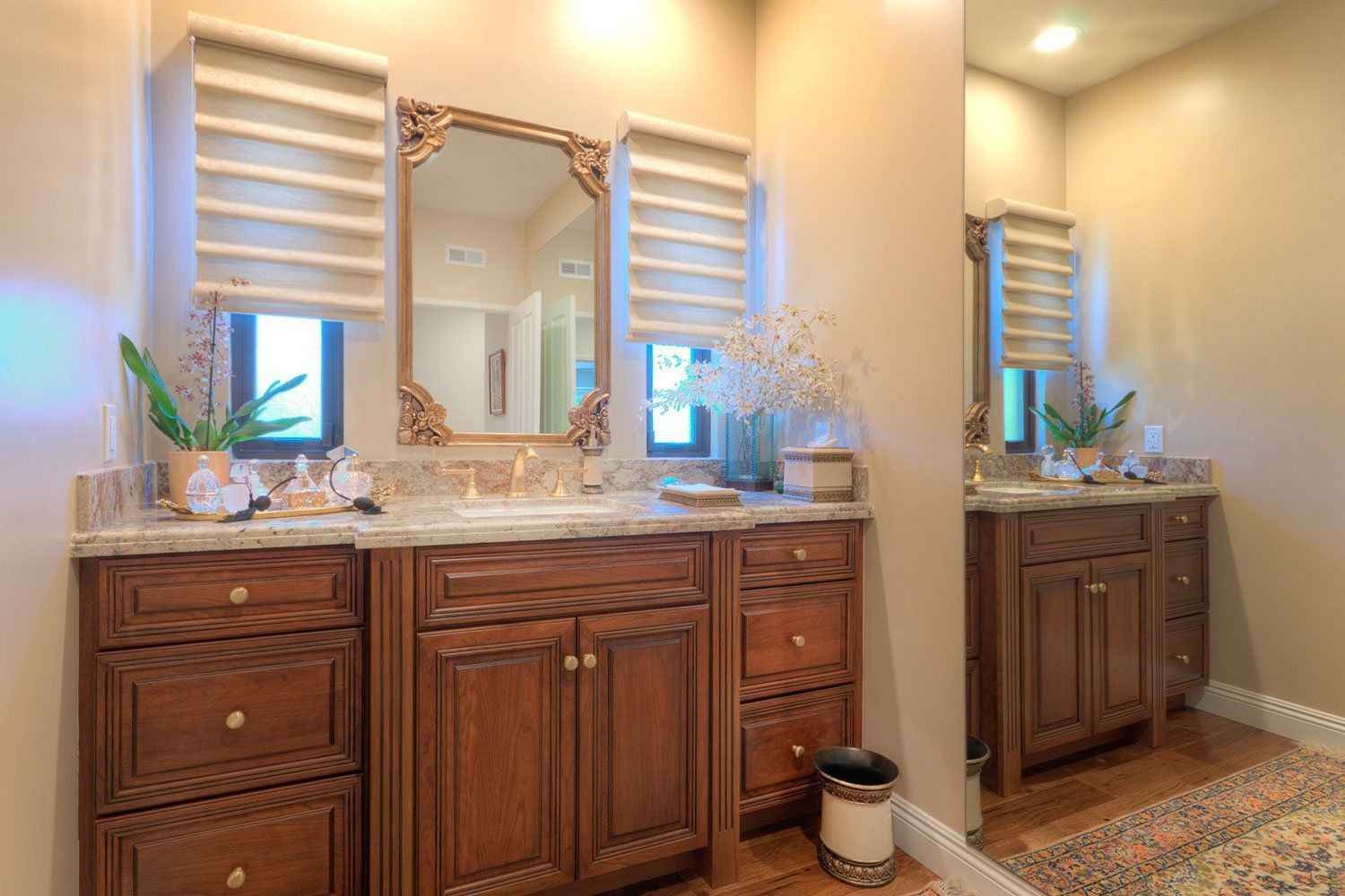 Double vanity bathroom with dark wood cabinets, large mirror, and striped window shades