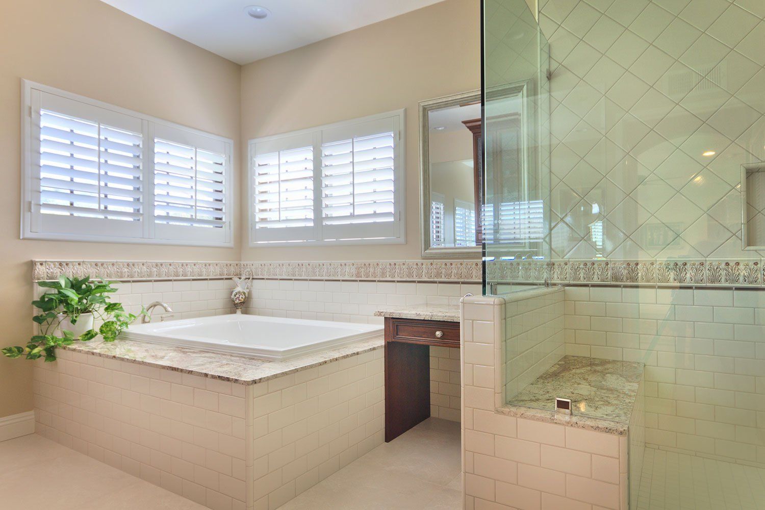 Bright bathroom with a soaking tub, large windows, and a glass-enclosed shower