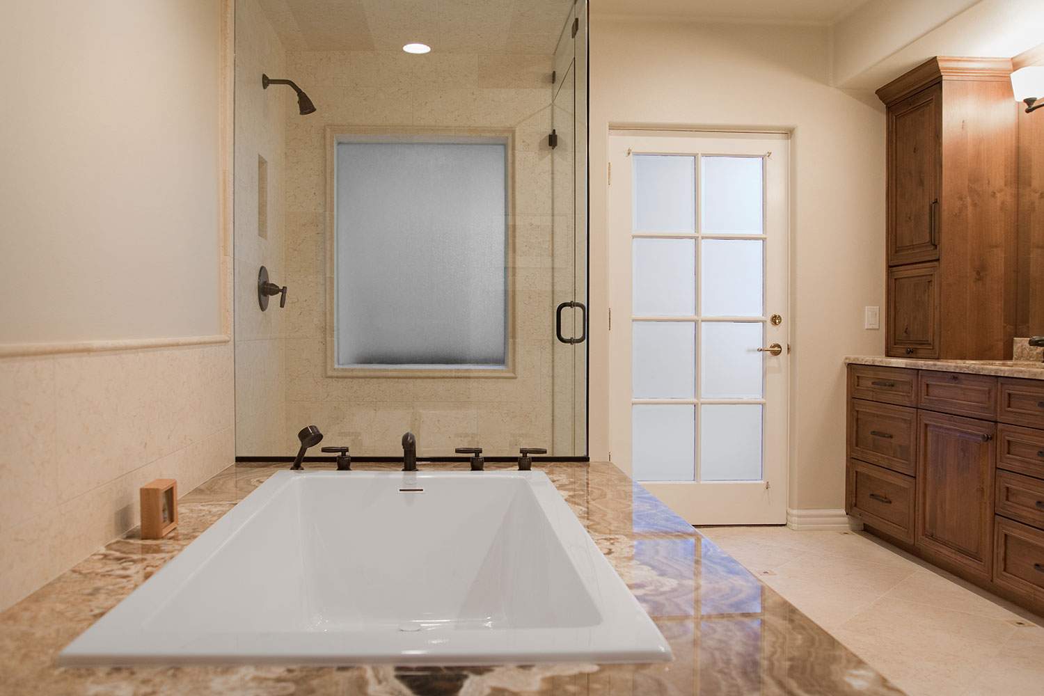 Modern bathroom with a freestanding tub, glass shower, and wood vanity
