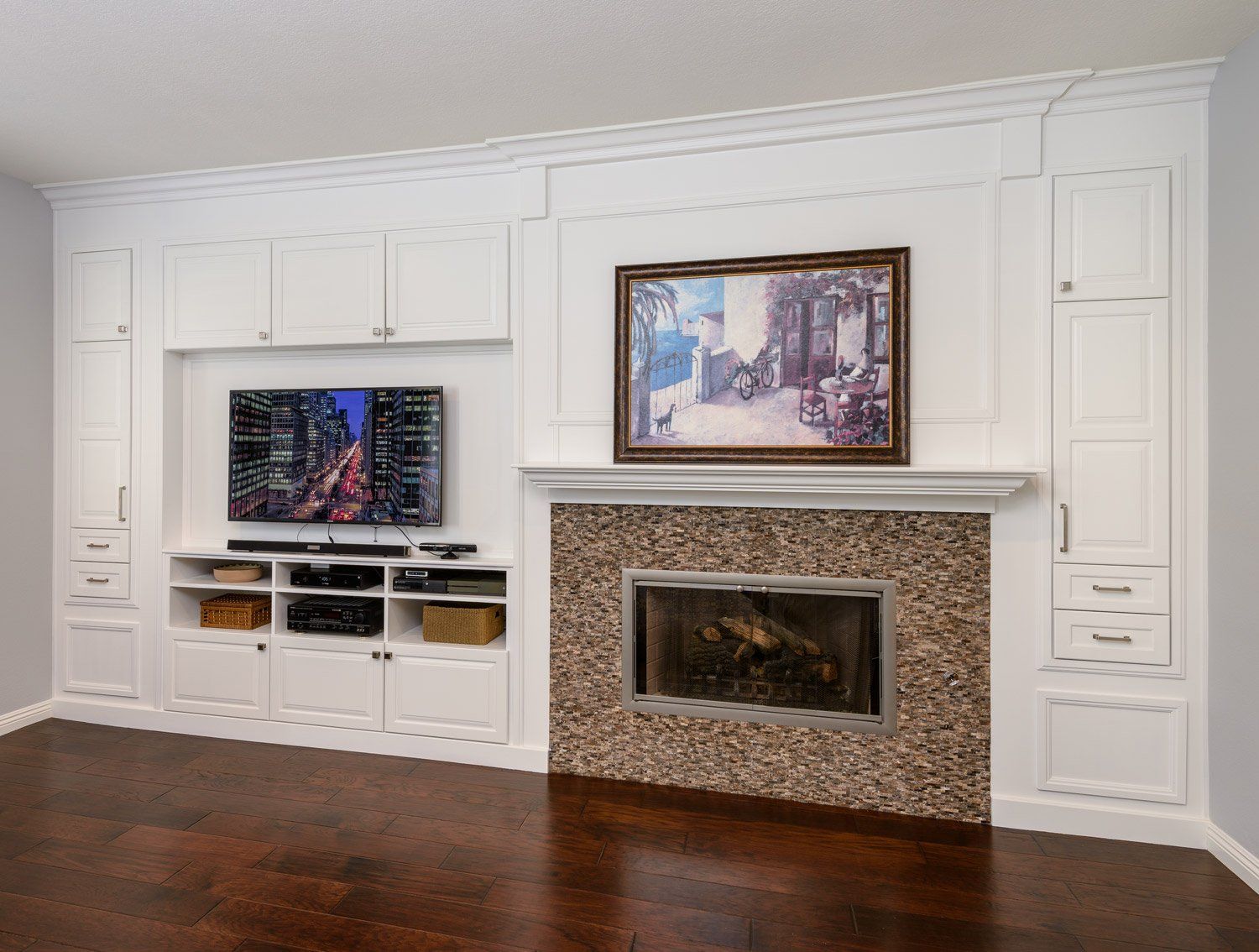 White living room wall with built-in TV, fireplace, and dark wood floor