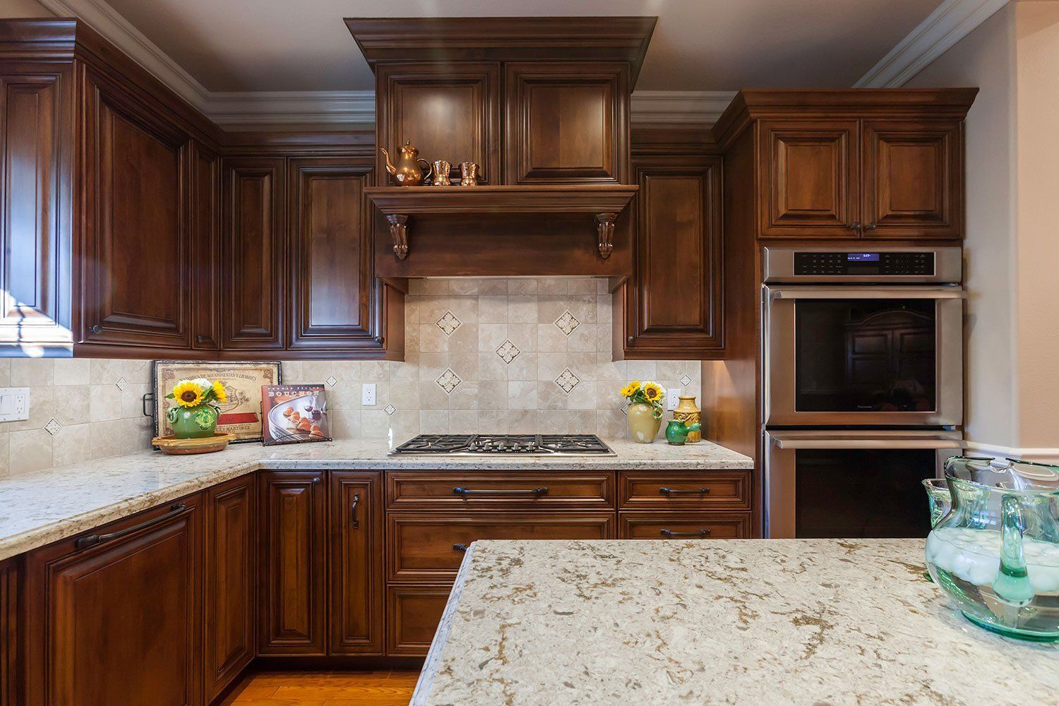Elegant kitchen with dark wood cabinets, granite island, and stainless steel appliances