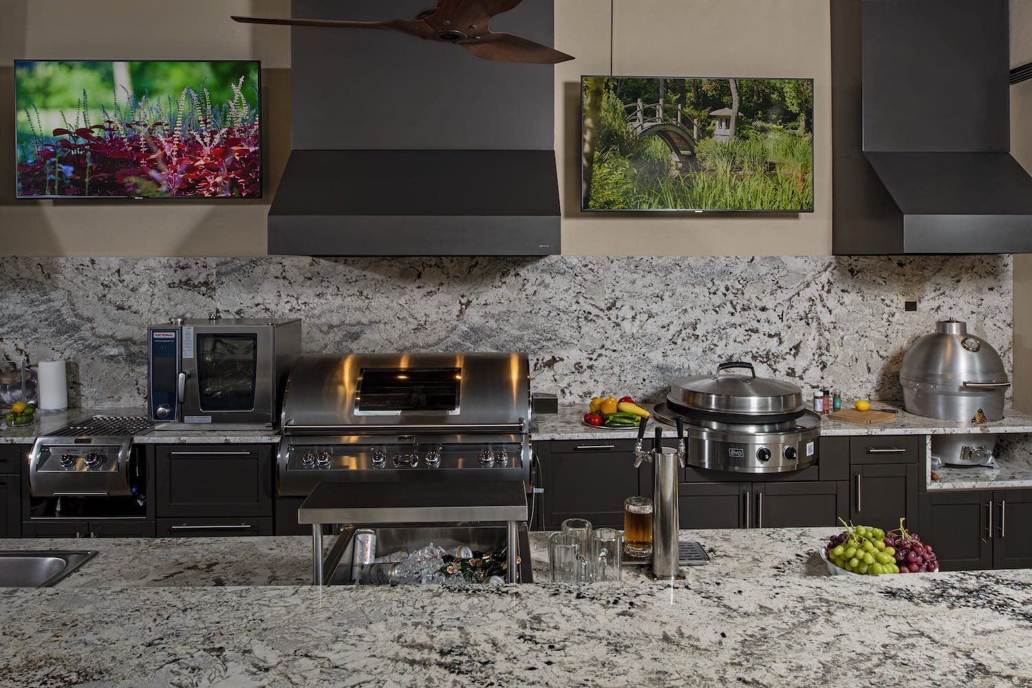 Modern kitchen counter with stainless steel appliances, pots, and framed photos above a granite backsplash