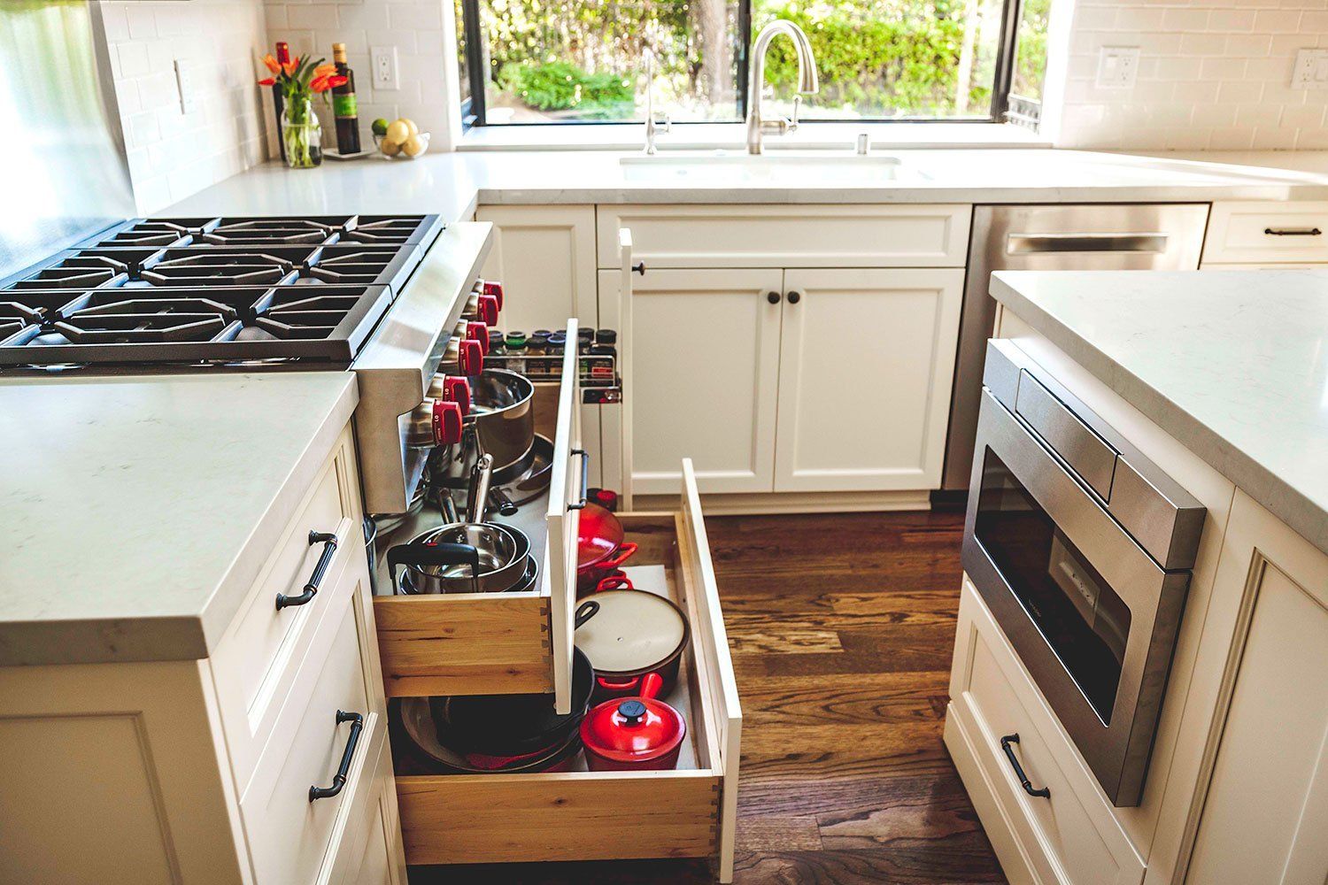 Kitchen with pull-out spice racks beside the stove and a built-in oven on the right.