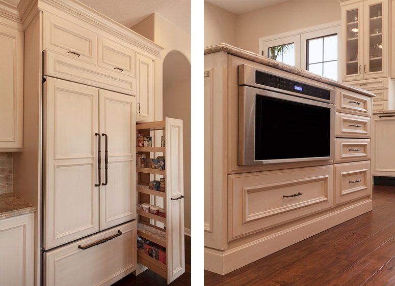 Built-in kitchen cabinets in cream finish, including a refrigerator and TV nook in a bright wood-floored room