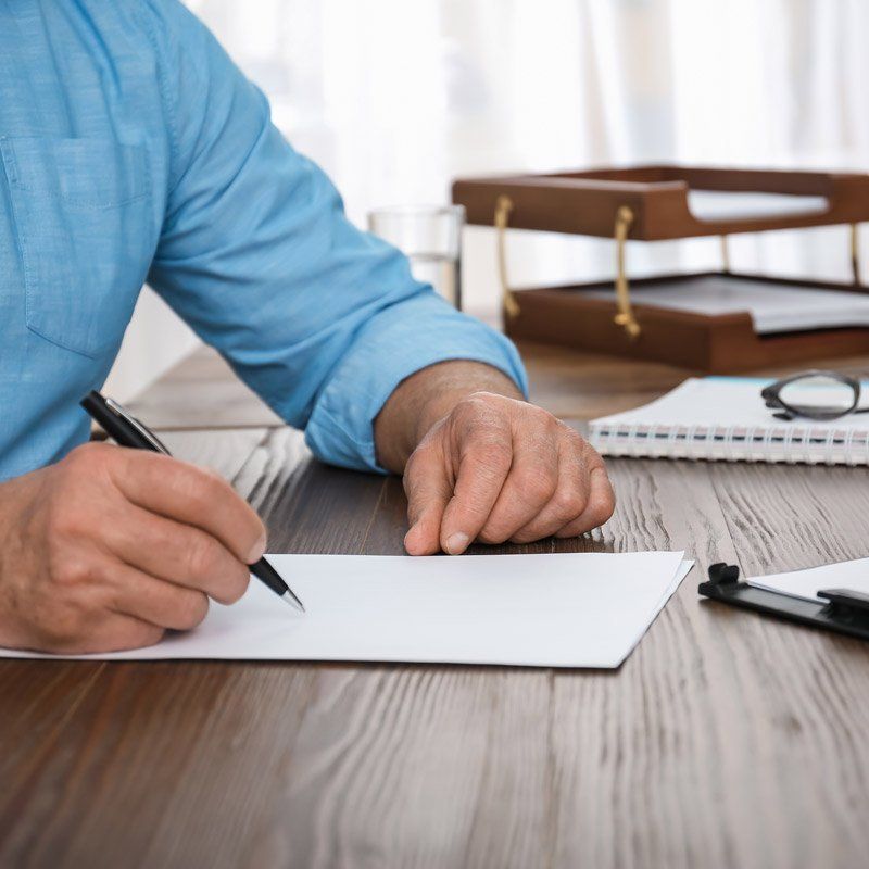 man signing paper