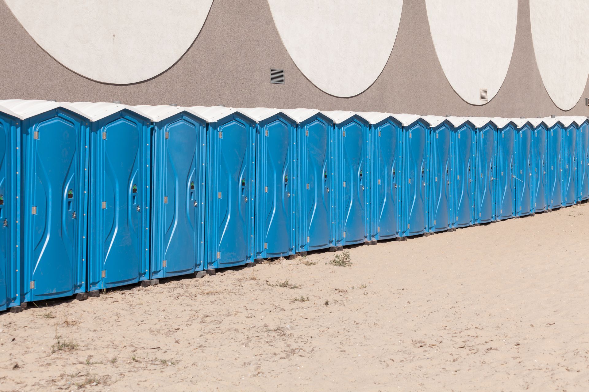 Row of portable toilets available for outdoor events and construction sites