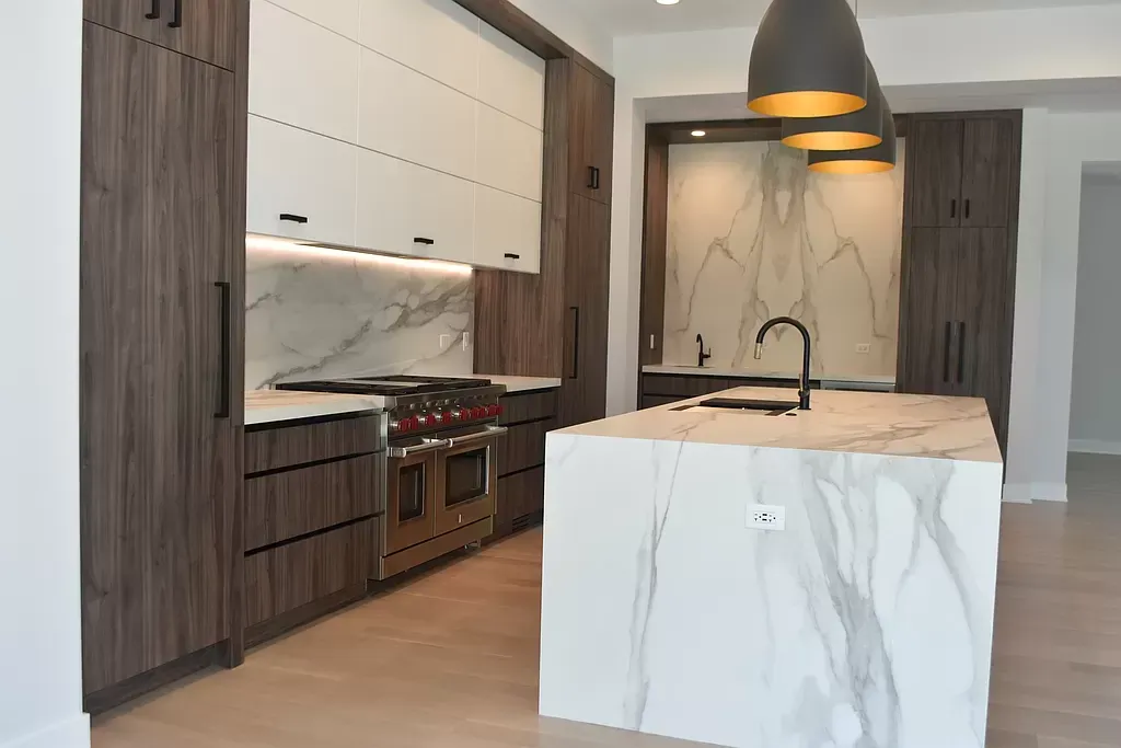 A bathroom with a walk in shower and a sink.