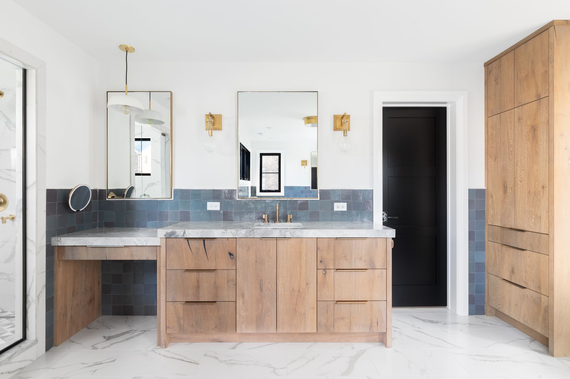 A bathroom with a sink , mirror , cabinets and drawers.