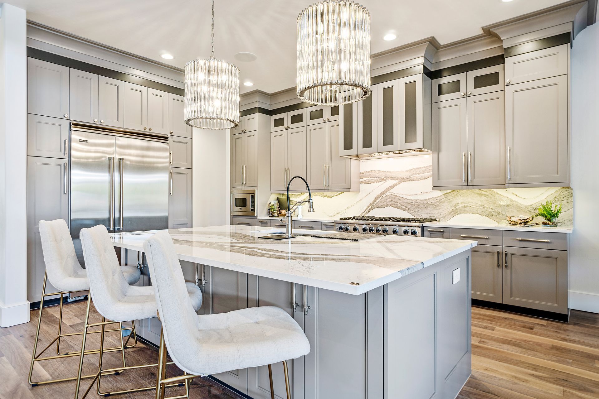 A kitchen with a large island and stainless steel appliances.