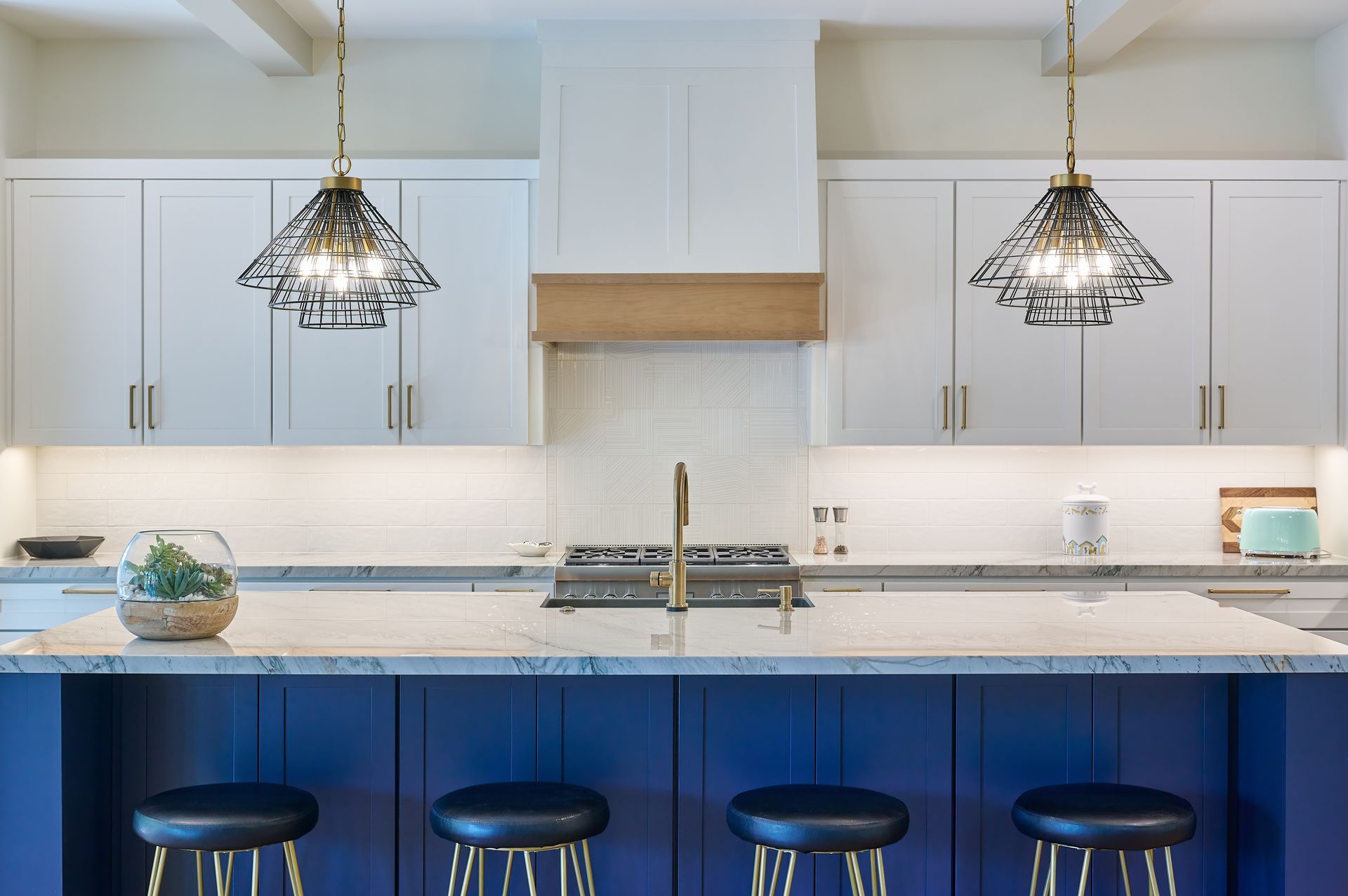 A kitchen with blue cabinets and white cabinets and a large island