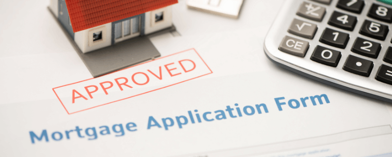 Mortgage application form approved, with a house model and calculator.