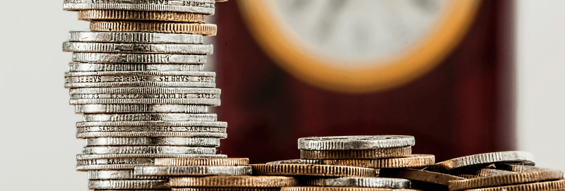 Stacks of coins against a dark background.