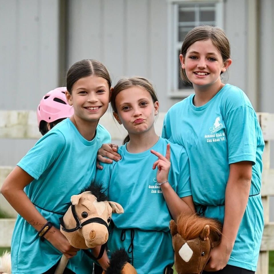 photo of Lenux Stables academy rider and instructor looking at prize after winning horse show class