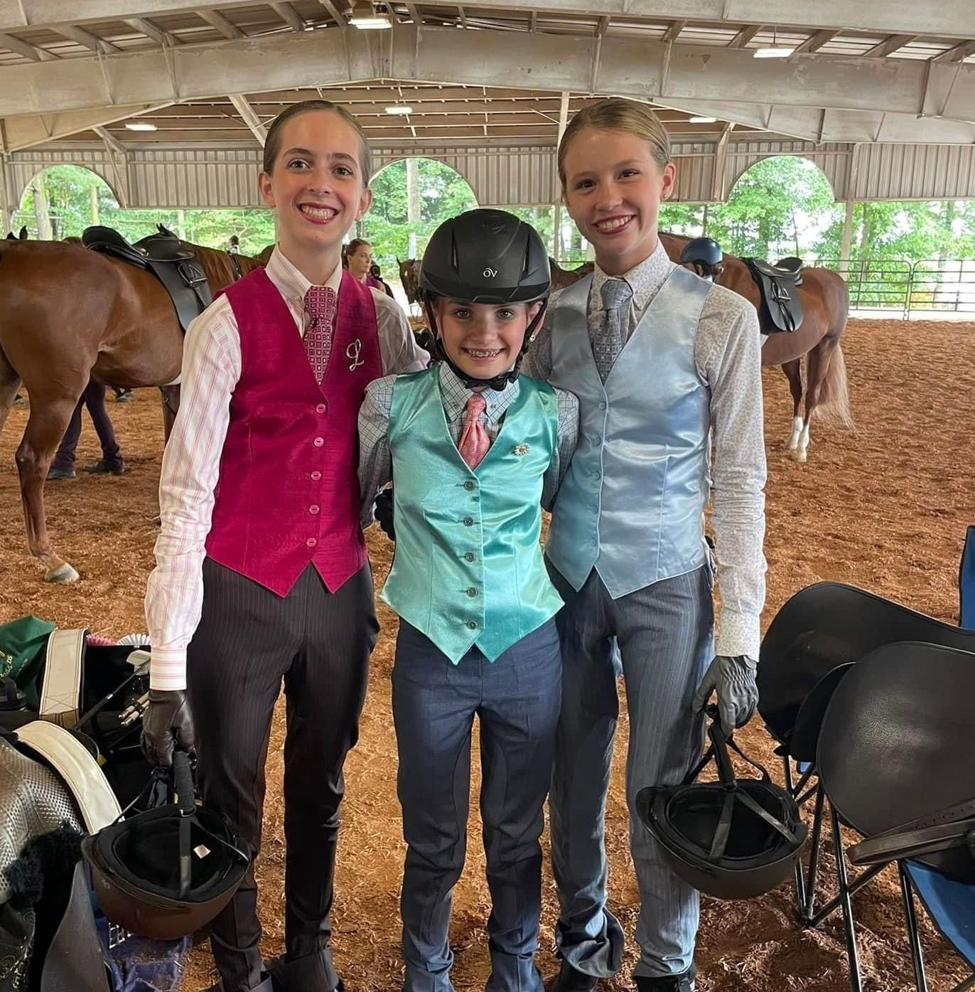 photo of smiling Lenux Stables academy rider sitting on horse following horse show class