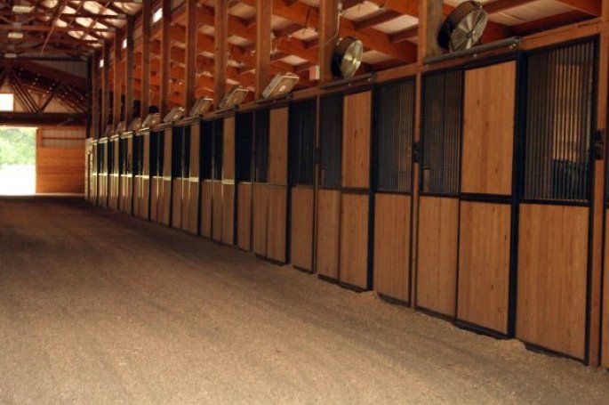 Picture of Lenux Stables main barn aisle with show horse training stalls
