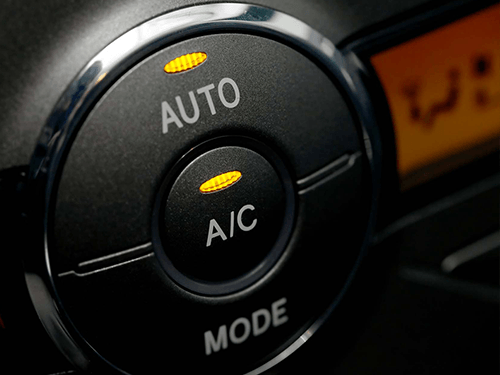 A close up of an auto and a/c mode button