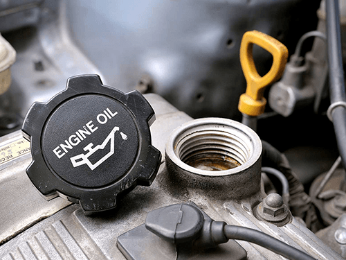 A close up of an engine oil cap on a car