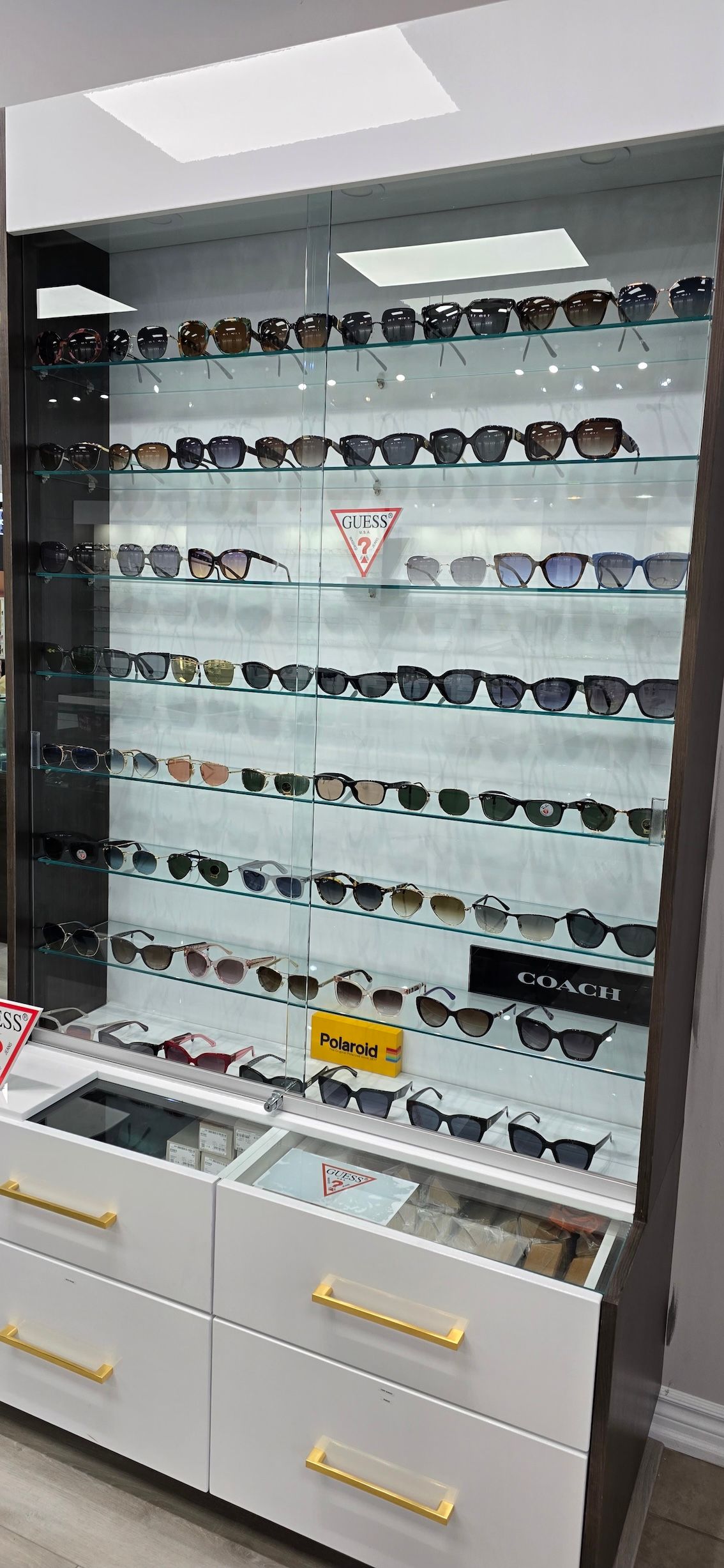 A display case filled with lots of sunglasses in an optical shop.