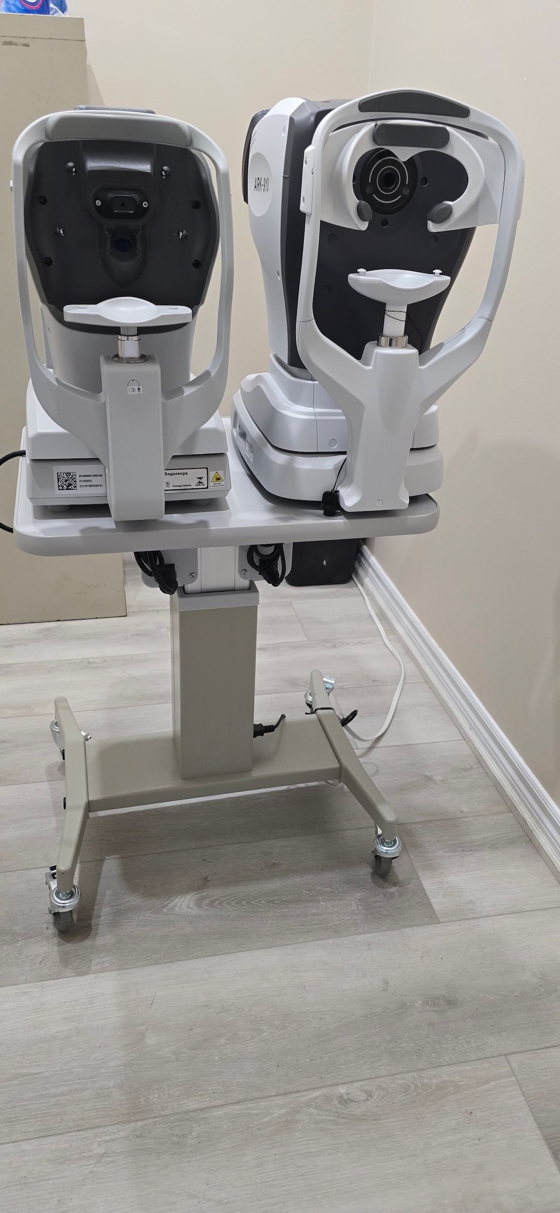 Two ophthalmic equipment are sitting on a table.