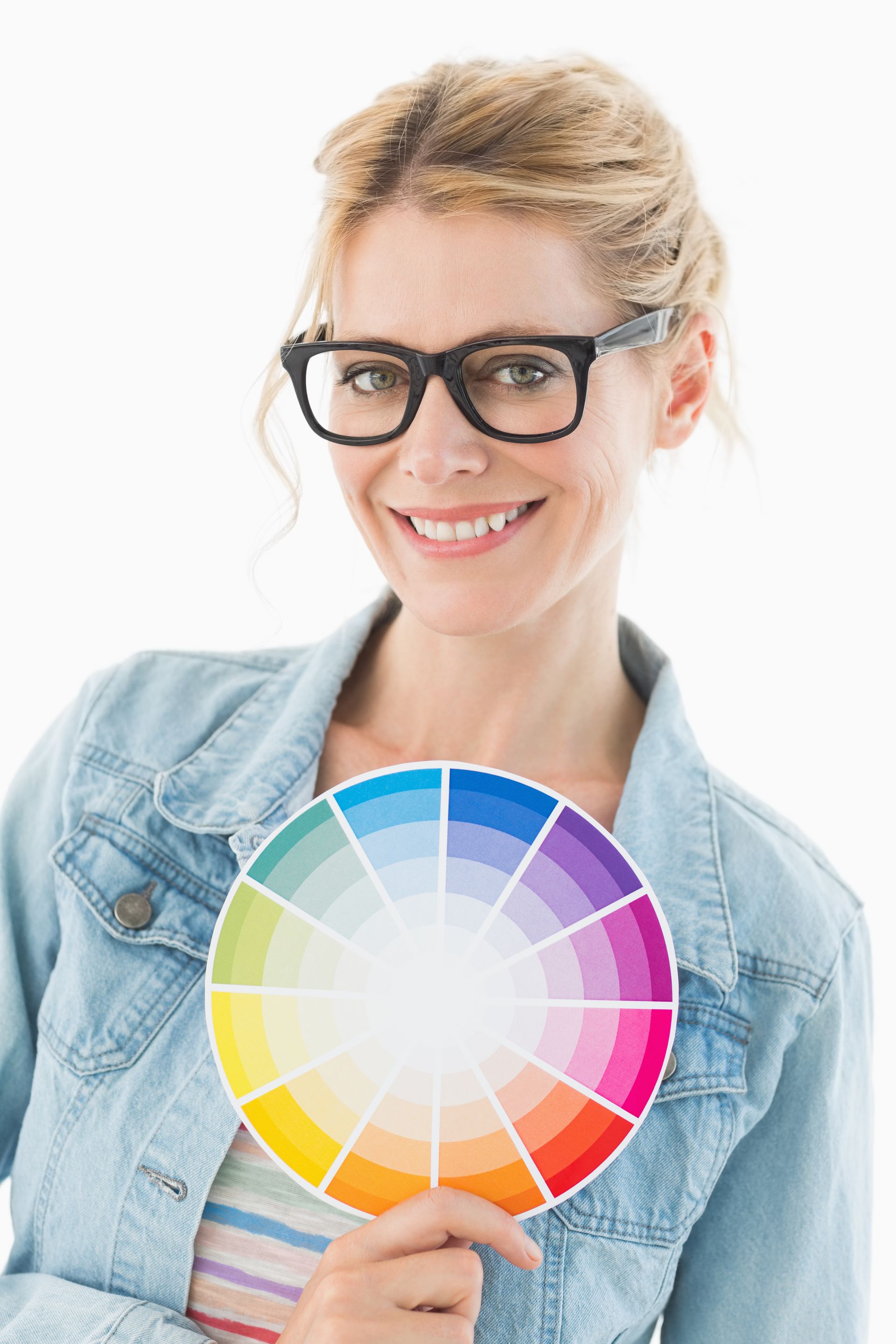 A woman wearing glasses is holding a color wheel.