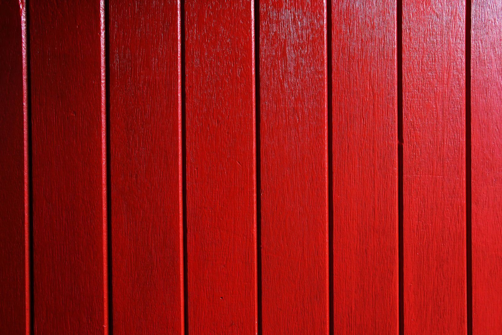 A close up of a red wooden fence.