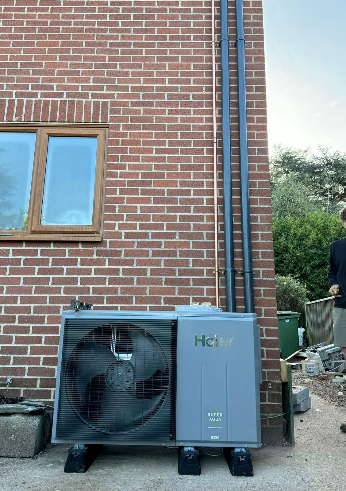 A brick building with a fan on the side of it