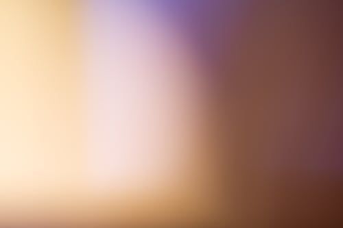 Blurred gradient of golden, light purple and brown colors.