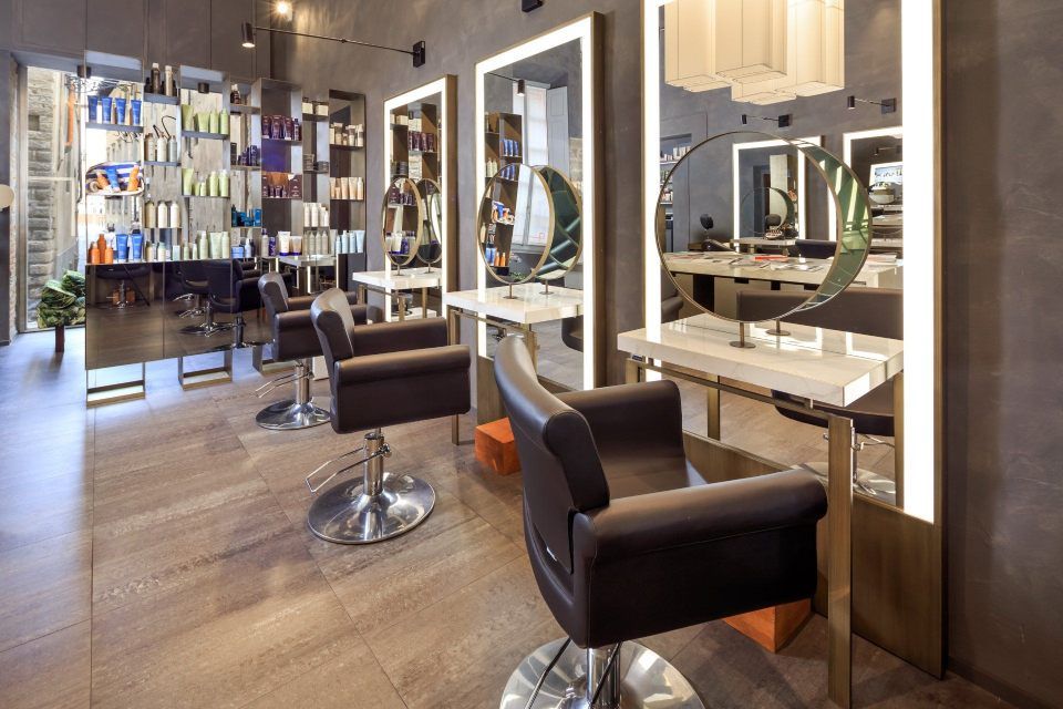 Salon interior with mirrors, styling chairs, and product display.