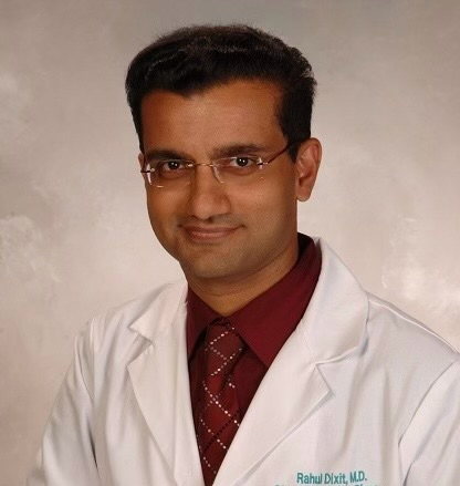 A man in a lab coat with the name rahul on it