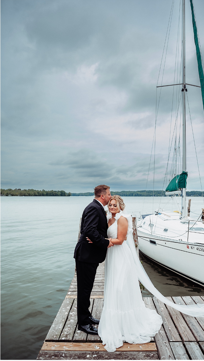 Wedding ceremony outdoors: bride and groom at altar, guests seated on grass, sunny day.