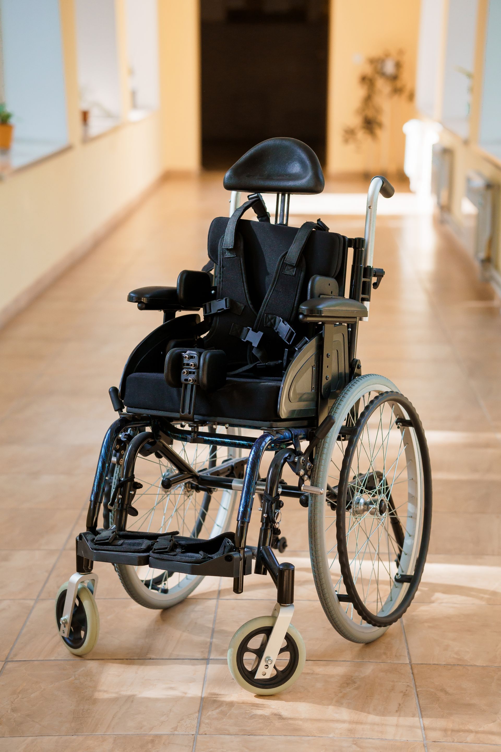 Empty wheelchair in a bright hallway, facing forward