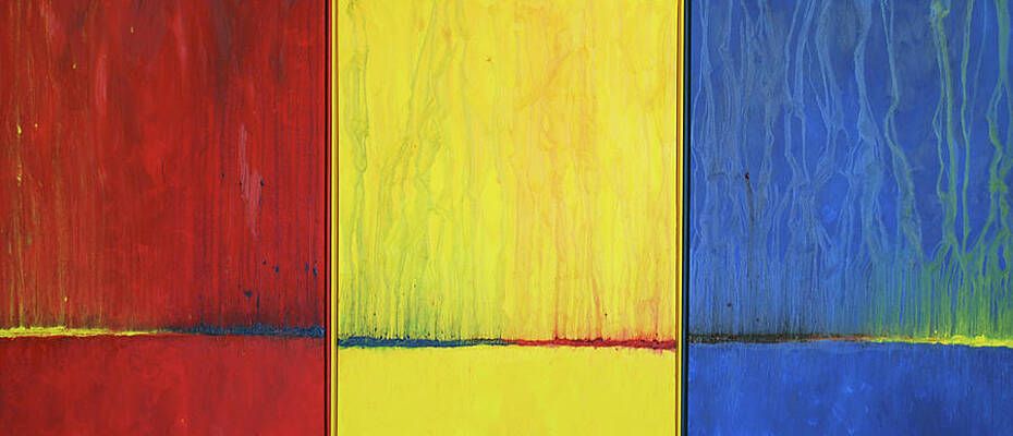 A close up of a red , yellow , and blue painting.