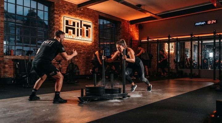 Member performing a sled push during a CrossFit-style POWER class at HIIT West Hampstead